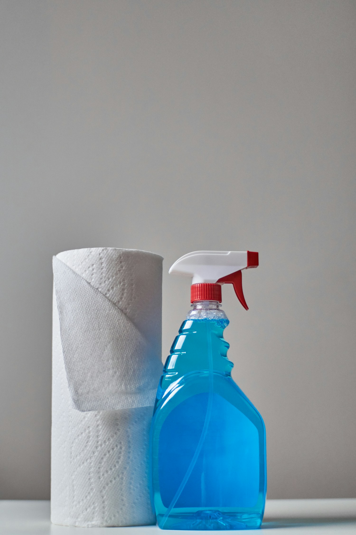 Clear spray bottle and towel on a clean counter
